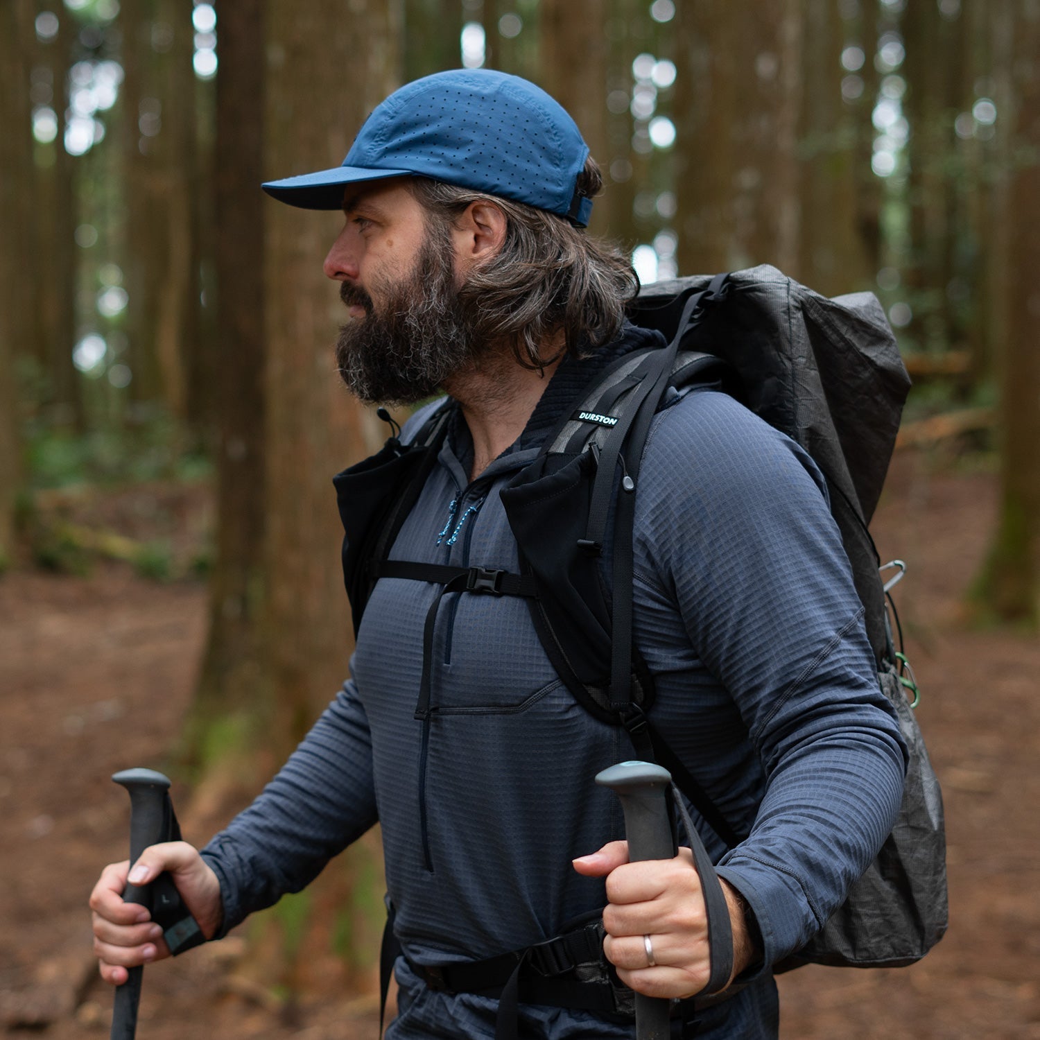 A hiker modeling a lightweight grid fleece midlayer 